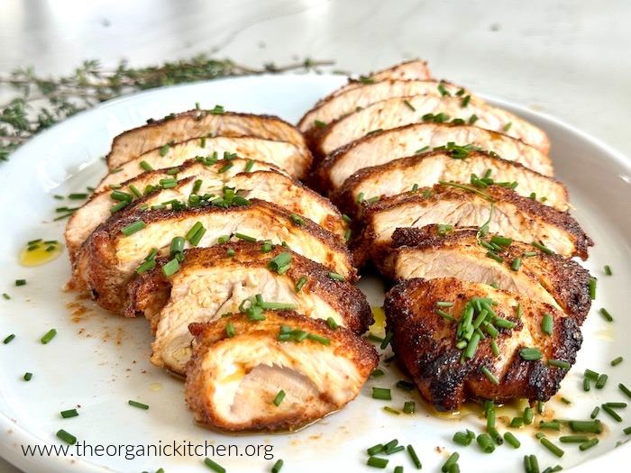 Easy Herbed Turkey Tenderloins on a white plate with thyme sprigs in the background