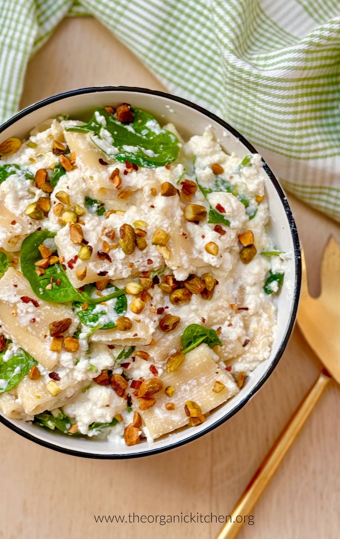 A large bowl of Creamy Lemon Rigatoni with Spinach garnished with pistachios