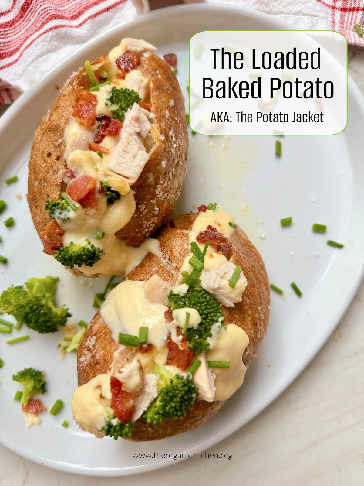 Two Loaded Baked Potatoes on white plate with red and white dish towel in background