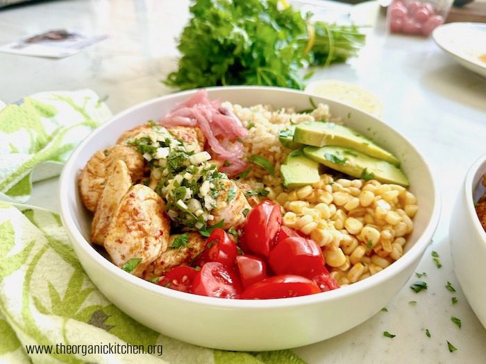 Harissa Chicken and Chimichurri Rice Bowl Harissa Chicken and Chimichurri Rice Bowl on marble counter with parsley in the background