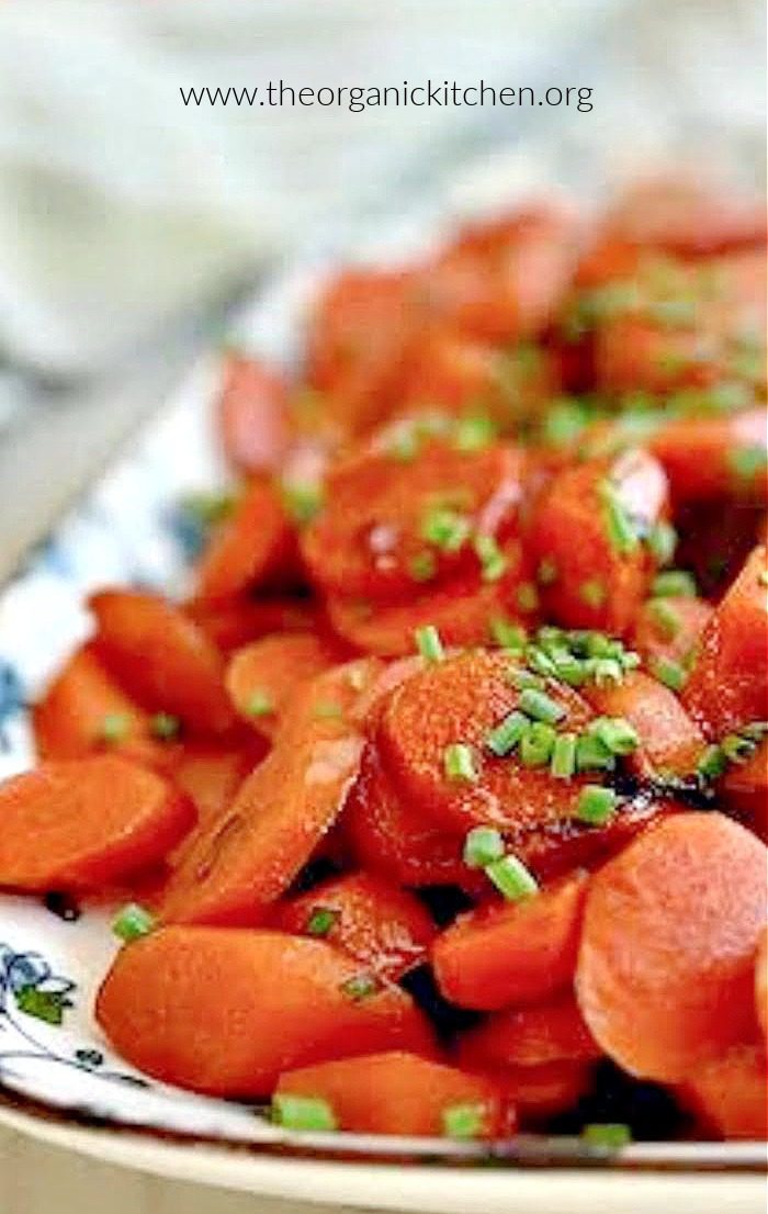Sauteed Carrots Three Ways garnished with chives on blue and white palte