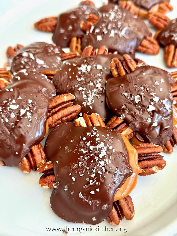 Easy Chocolate Pecan Turtles Easy Chocolate Pecan Turtles sprinkled with sea salt on white plate