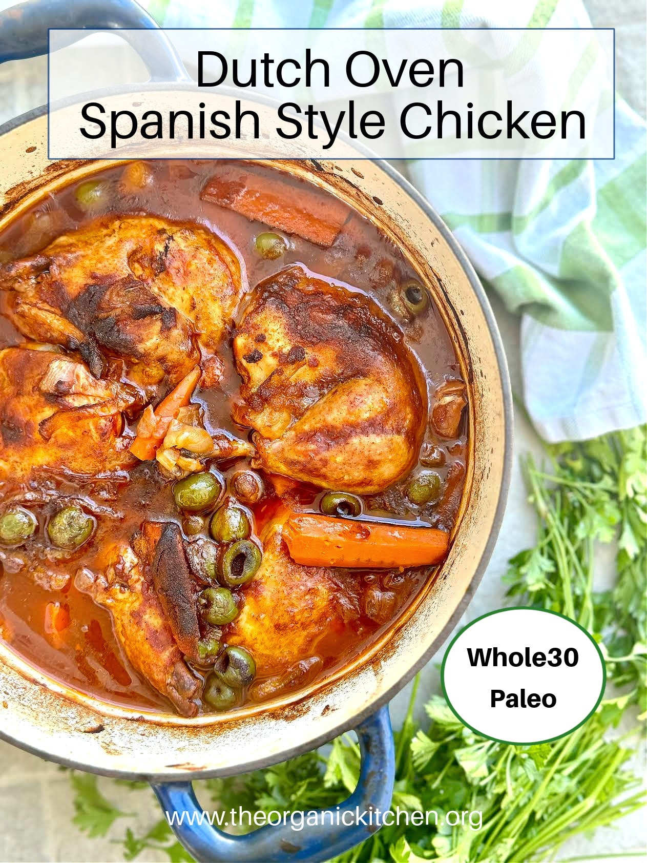 Dutch Oven Spanish Style Chicken in a blue pot surrounded by herbs and a green and white dish towel
