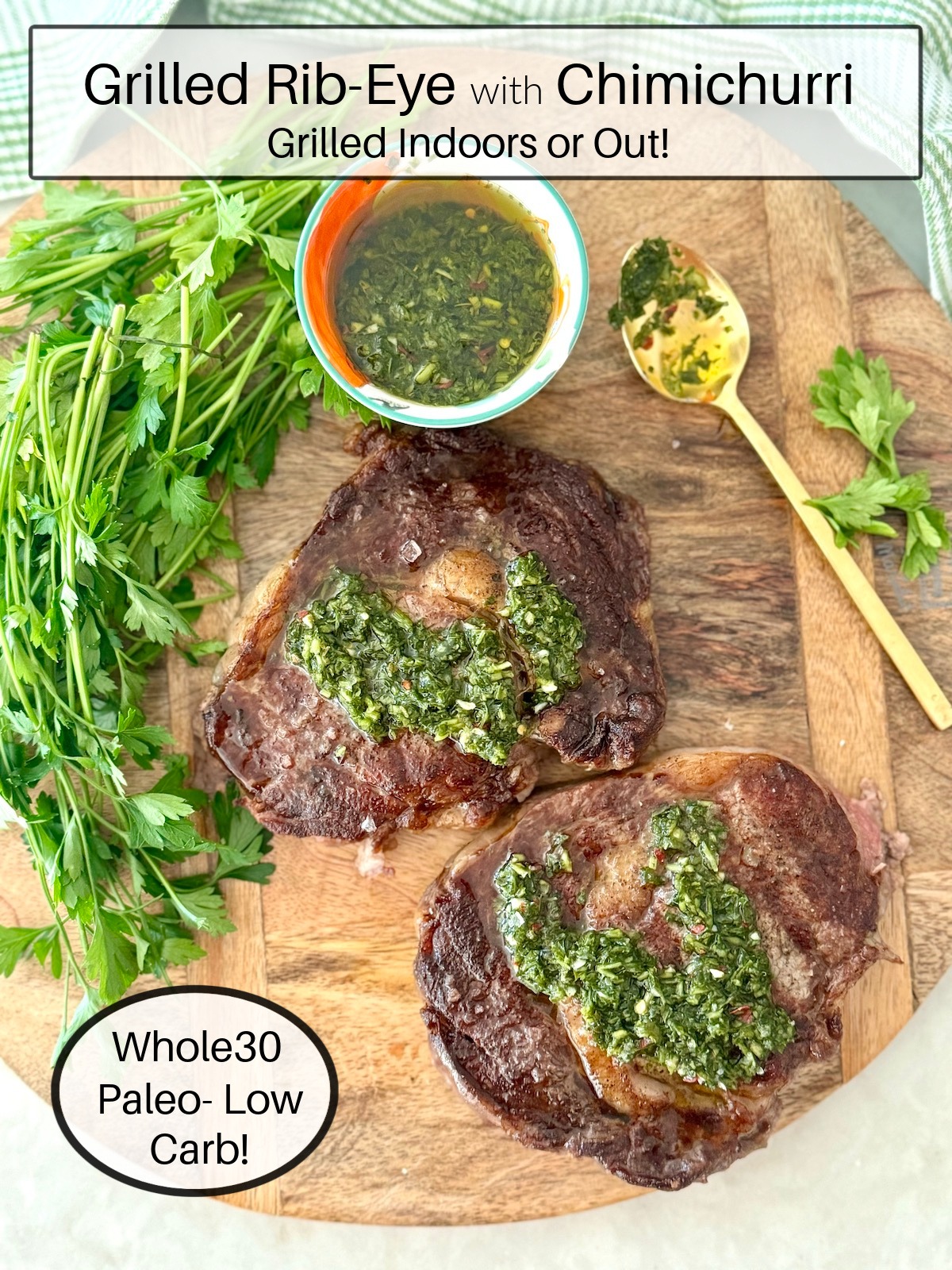 Grilled Rib-Eye Steaks with Chimichurri (Whole30) surrounded by herbs and a gold spoon on wood platter 
