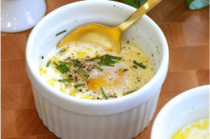 Eggs en Cocotte Eggs en Cocotte in white ramekin with gold spoon