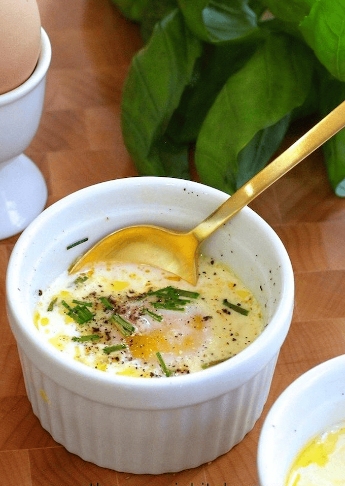 22 Egg Recipes You'll Love Eggs en Cocotte with gold spoon in white ramekin
