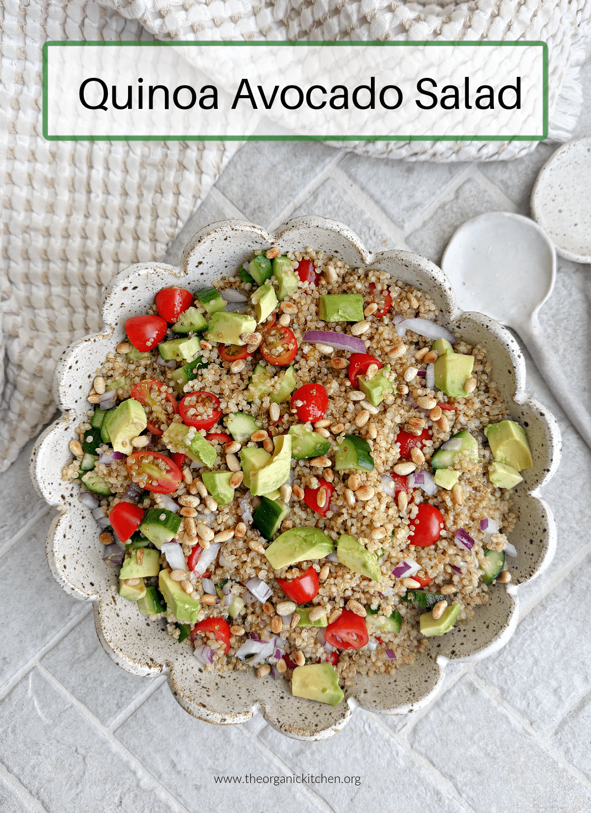 Quinoa Avocado Salad Quinoa Avocado Salad in a scallopede bowl on grey brick surface
