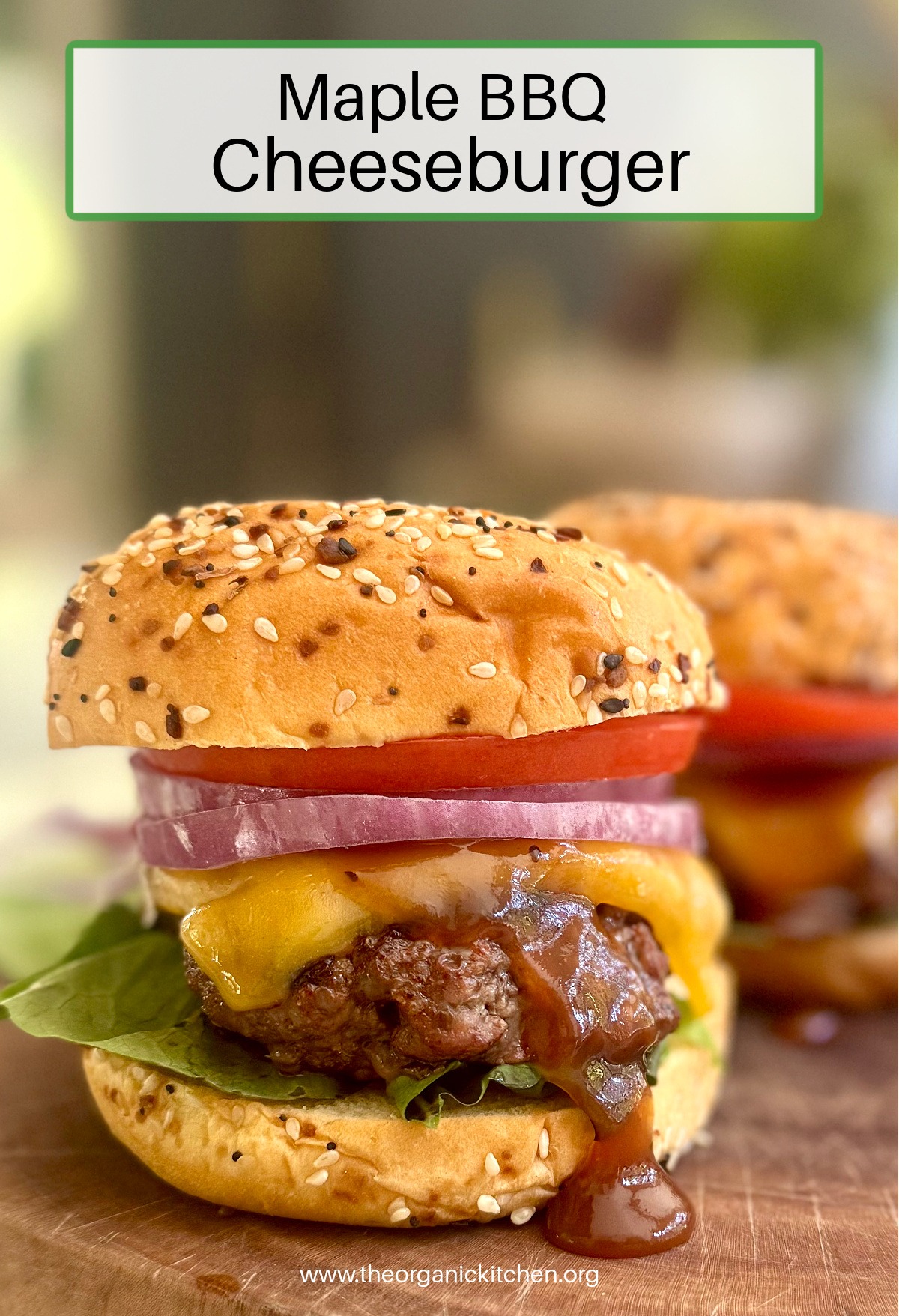 A Maple BBQ Cheeseburger on dripping with BBQ sauce and melted cheese on wood platter