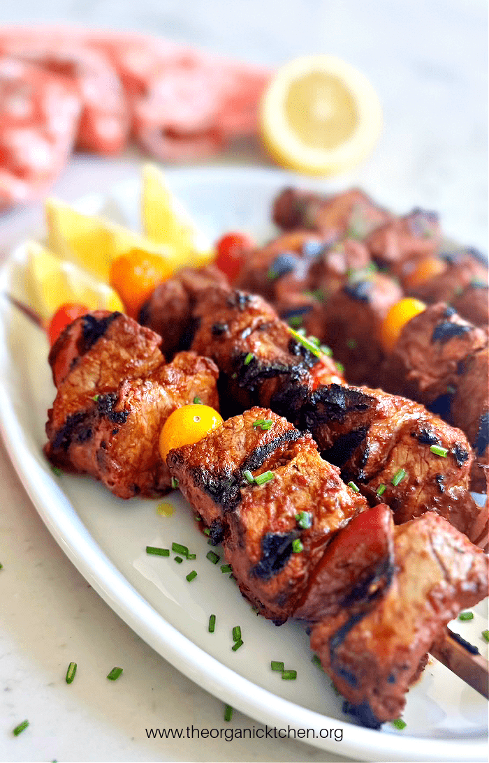 Grilled Beef Kabobs (Whole30, Keto-Low Carb) on white plate garnished with chives and lemon wedges