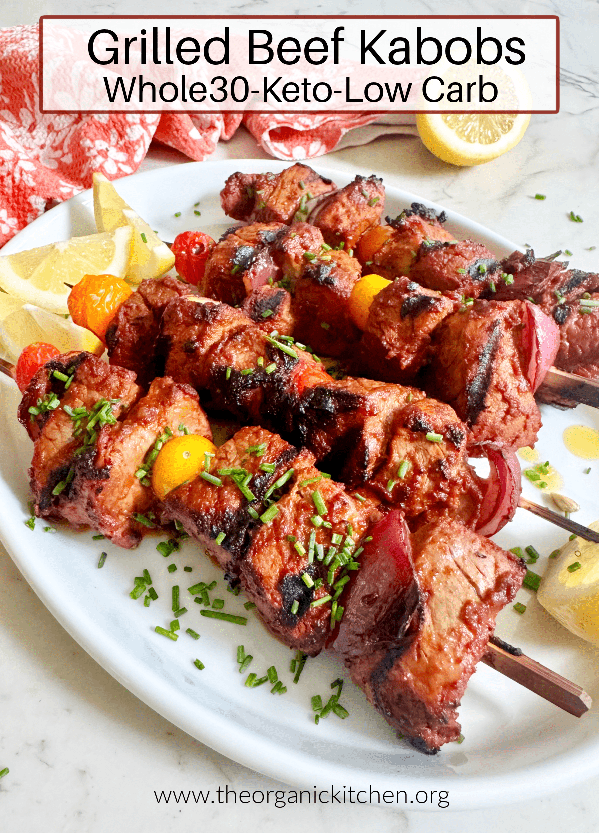 Grilled Beef Kabobs (Whole30, Keto-Low Carb) on white plate garnished with chives and lemon wedges