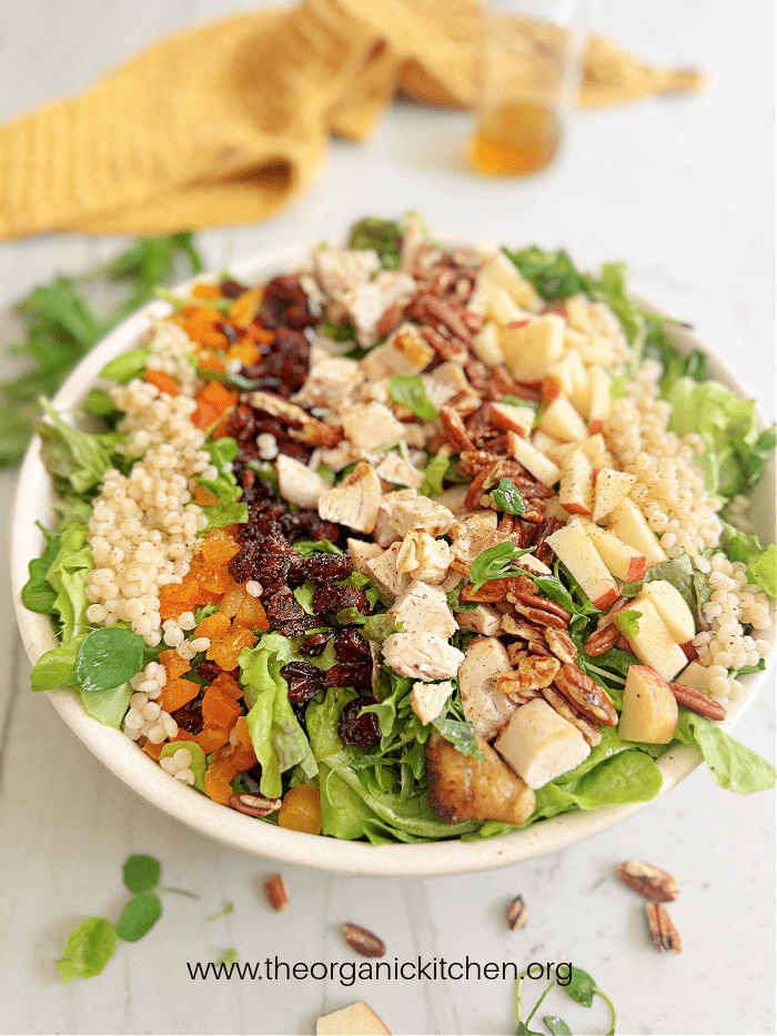 The Harvest Salad The Harvest Salad with couscous, apples, chicken and cranberries in a white bowl with yellow dish towel in the background