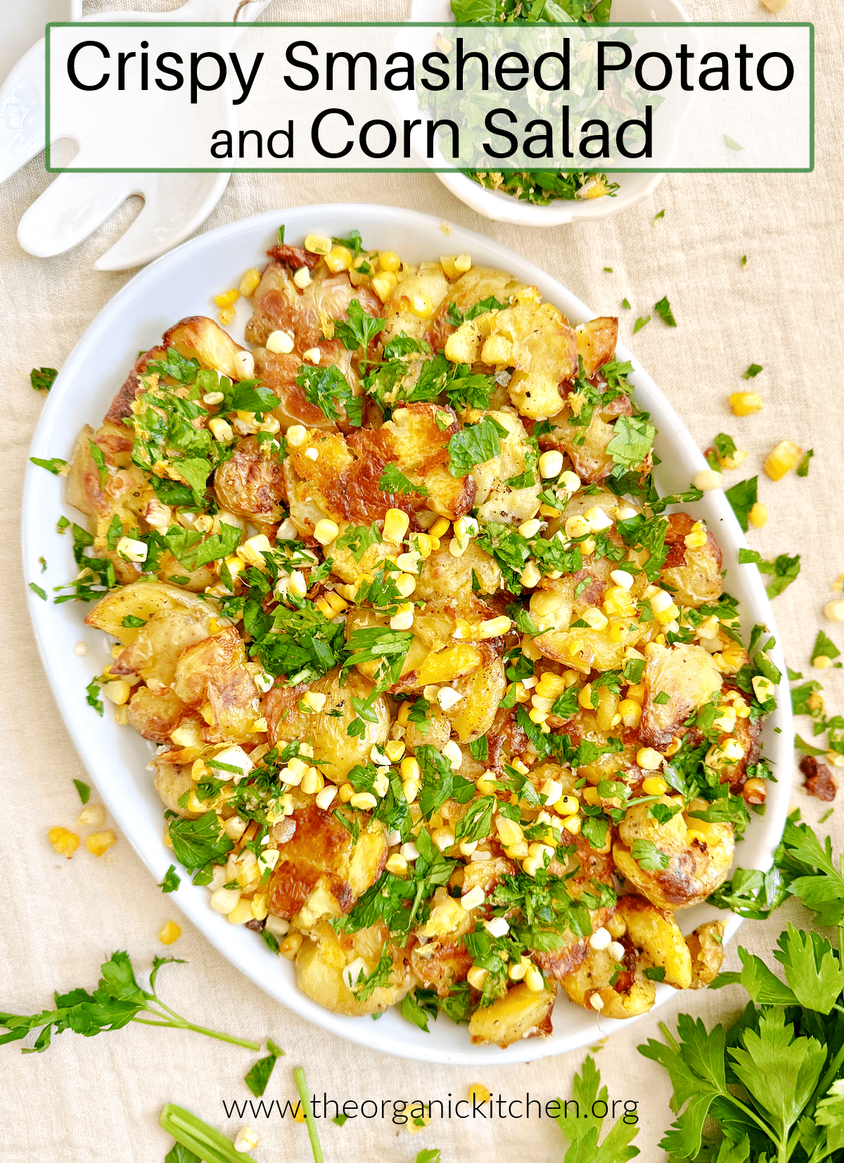 Crispy Smashed Potato and Corn Salad garnished with herbs on white plate 