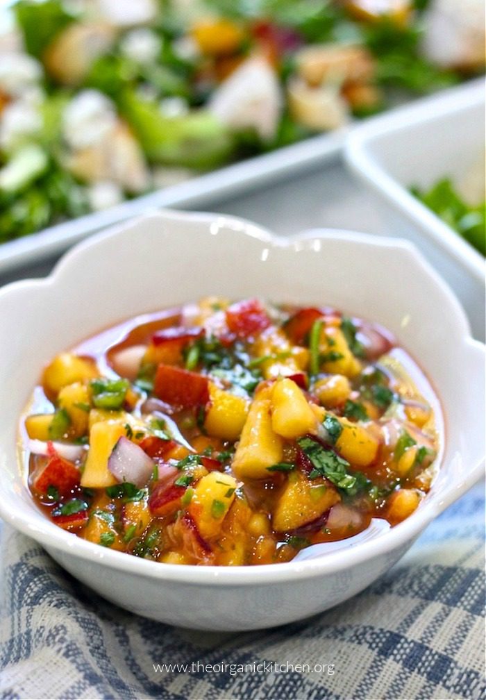 Fresh Peach Salsa Fresh Peach Salsa in white bowl with a salad in the background