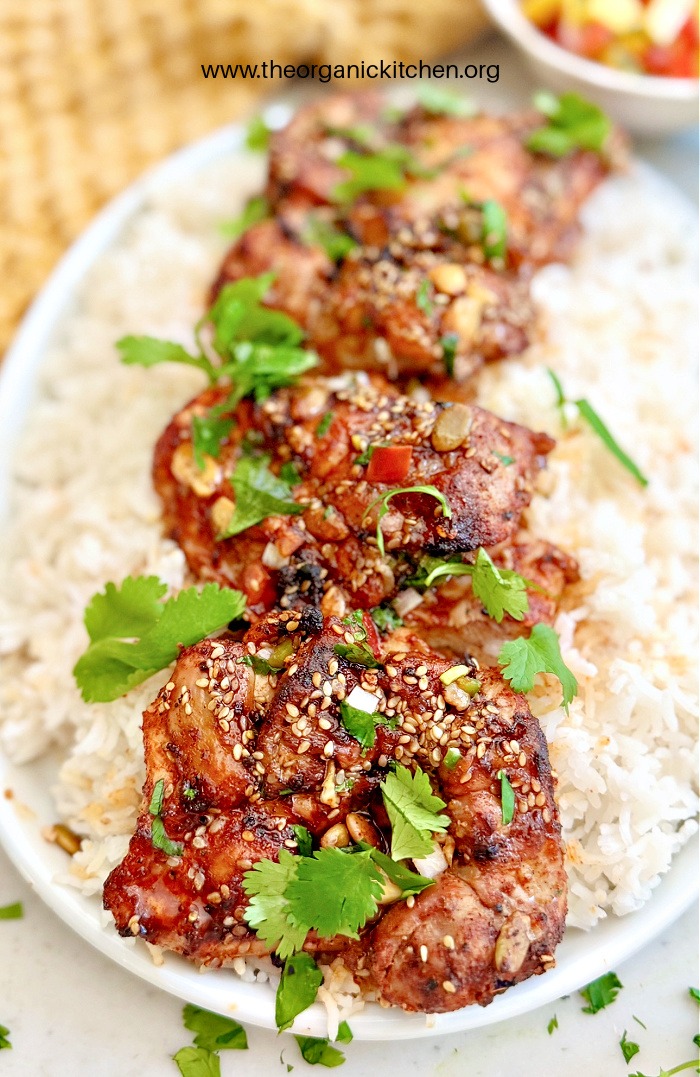 Air Fryer Hot Honey Chicken on a bed of rice, garnished with cilantro.
