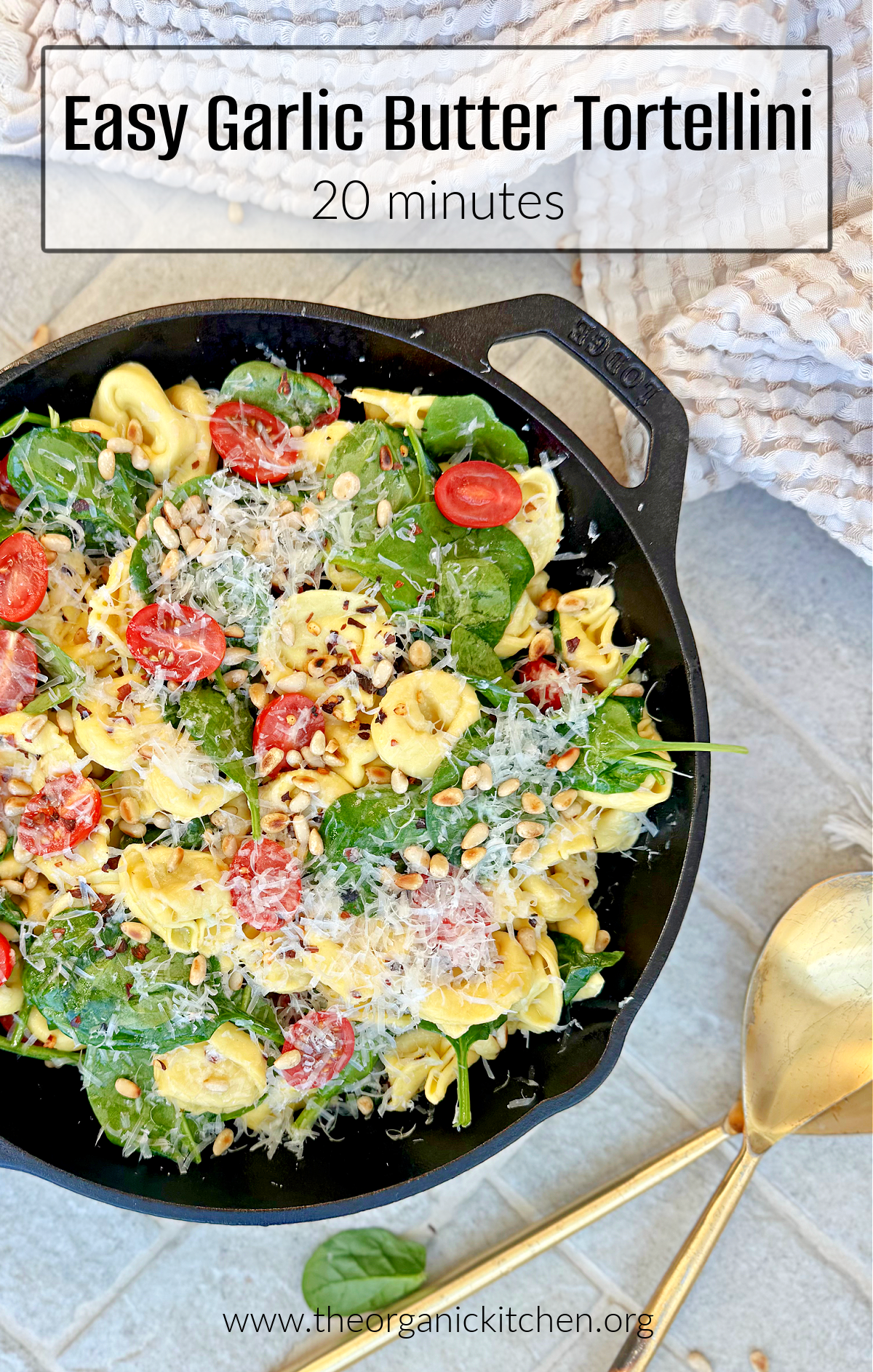 Easy Garlic Butter Tortellini Easy Garlic Butter Tortellini garnished with parmesan pine nuts in black cast iton pan with gold spoons