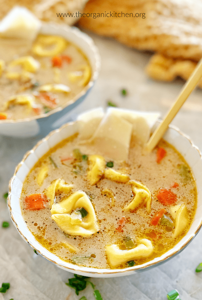 Easy Creamy Tortellini Soup in bowls with dish towel in the background