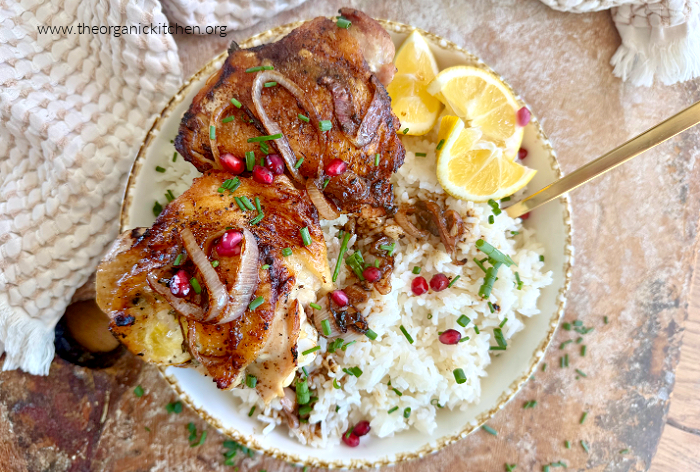 Buttery Lemon Thyme Chicken Thighs Buttery Lemon Thyme Chicken Thighs on a bed of rice in a beige bowl on a weathered wood cutting board