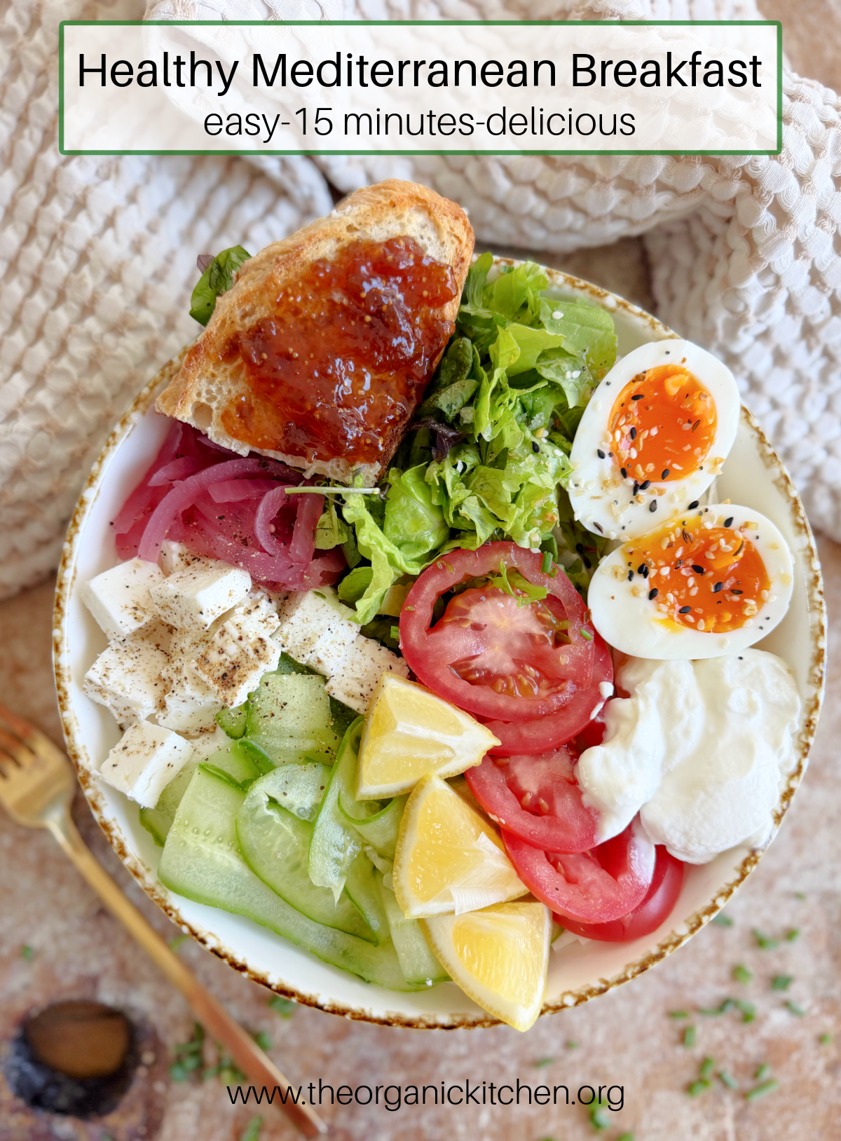 Healthy Mediterranean Breakfast Healthy Mediterranean Breakfast: greens, soft boiled eggs, cucumber, tomatoes, greens and a piece of toast in a bowl, chives and gold spoon an the side