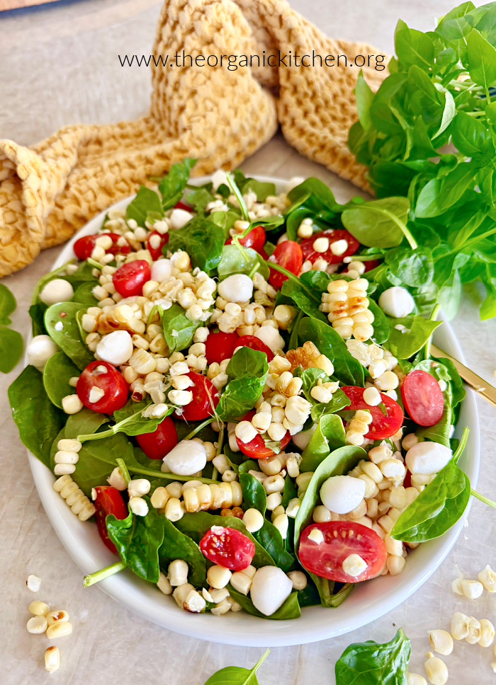 15 Recipes Using Cherry Tomatoes 15 Recipes Using Cherry Tomatoes: Corn, Tomato and Mozzarella Salad on white platter with yellow dish towel in the background