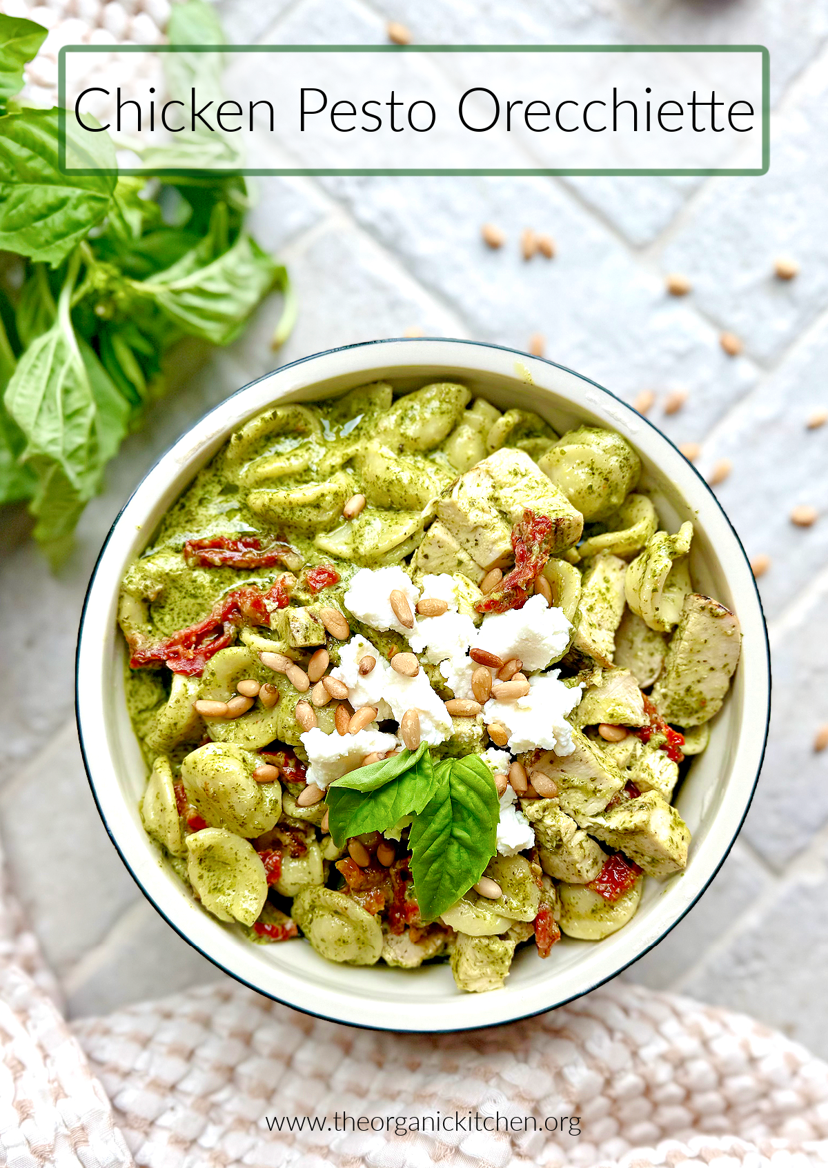Chicken Pesto Orecchiette Chicken Pesto Orecchiette in a white bowl on bricks scattered with basil and pine nuts