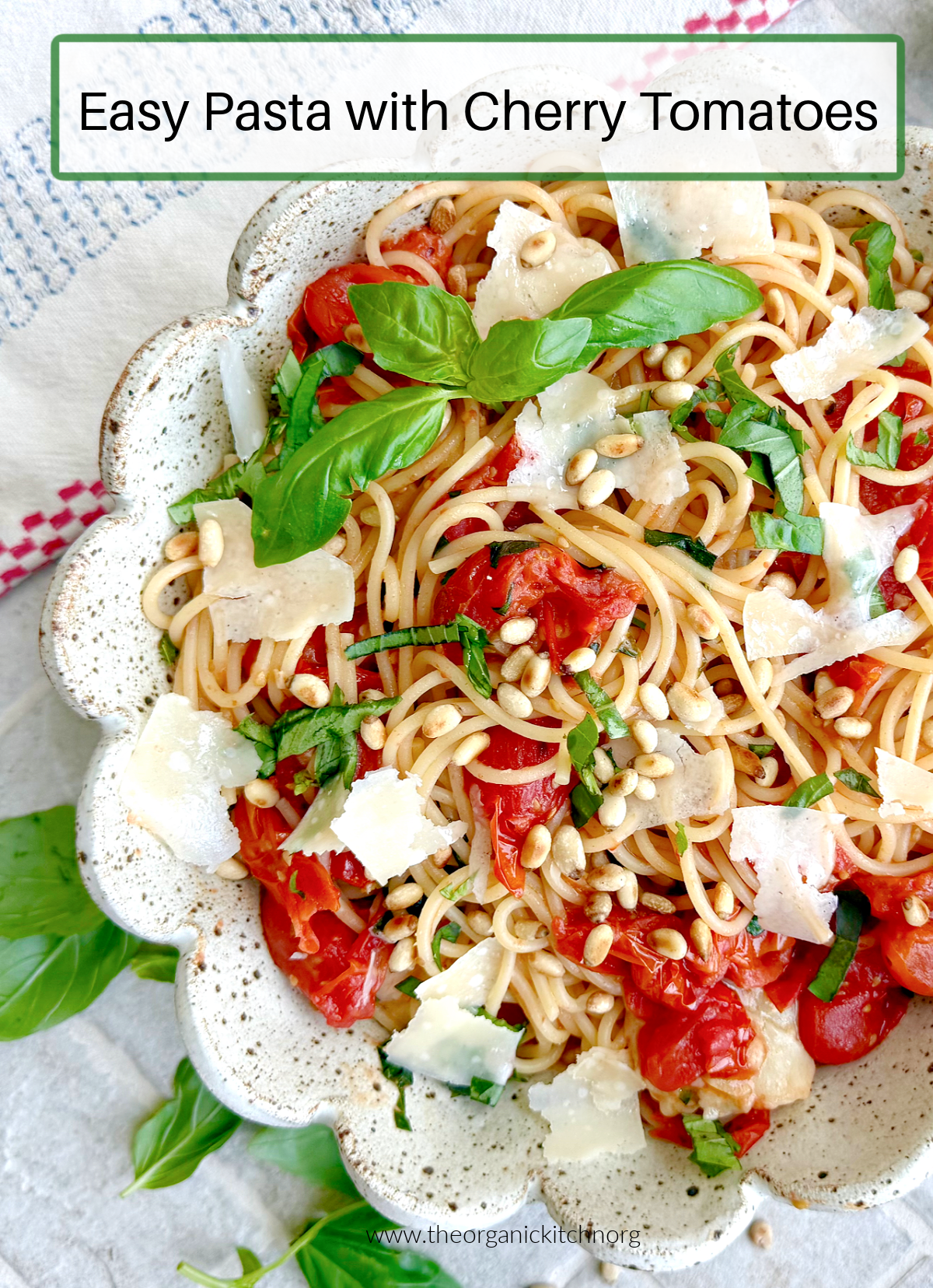 Easy Pasta with Cherry Tomatoes Easy Pasta with Cherry Tomatoes garnished with basil and parmesan in a scalloped bowl