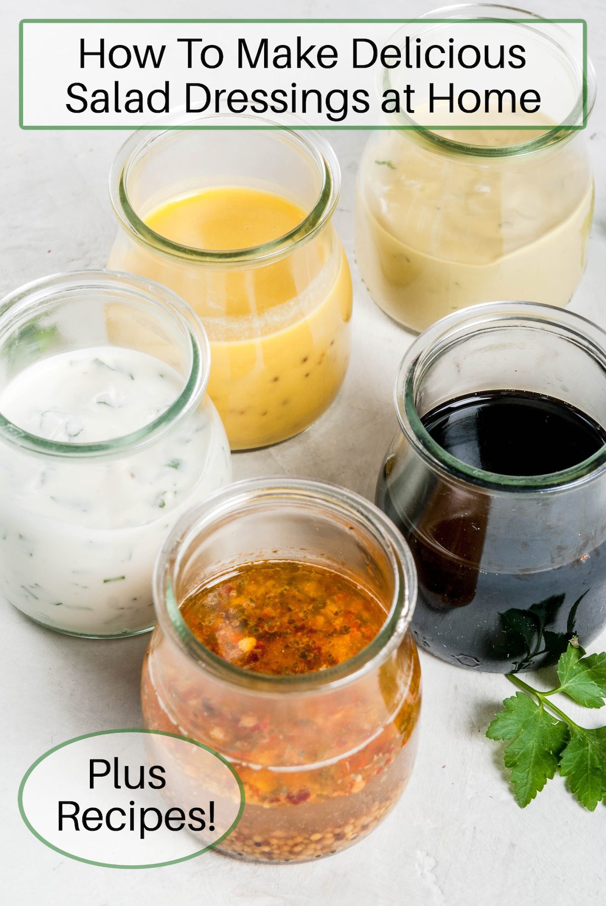 How to Make Delicious Salad Dressings at Home-Plus Recipes! Five bottles of various salad dressings in clear glass jars with a sprig of parsley