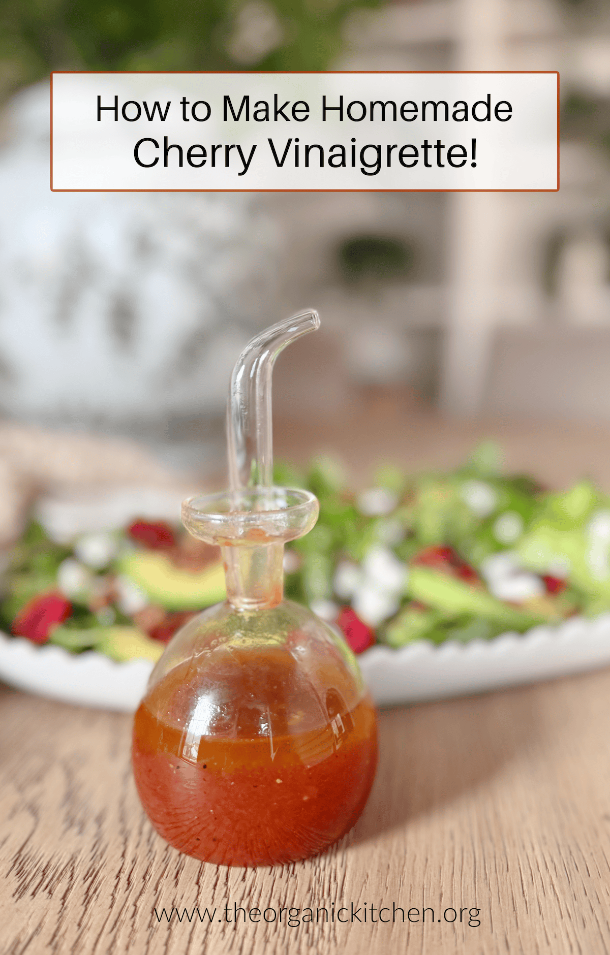 Homemade Cherry Vinaigrette A small bottle of Homemade Cherry Vinaigrette with a plate of salad in the background