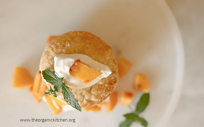 Old Fashioned Peach Shortcake Old Fashioned Peach Shortcake garnished with leaves of mint and diced peaches, on a white plate