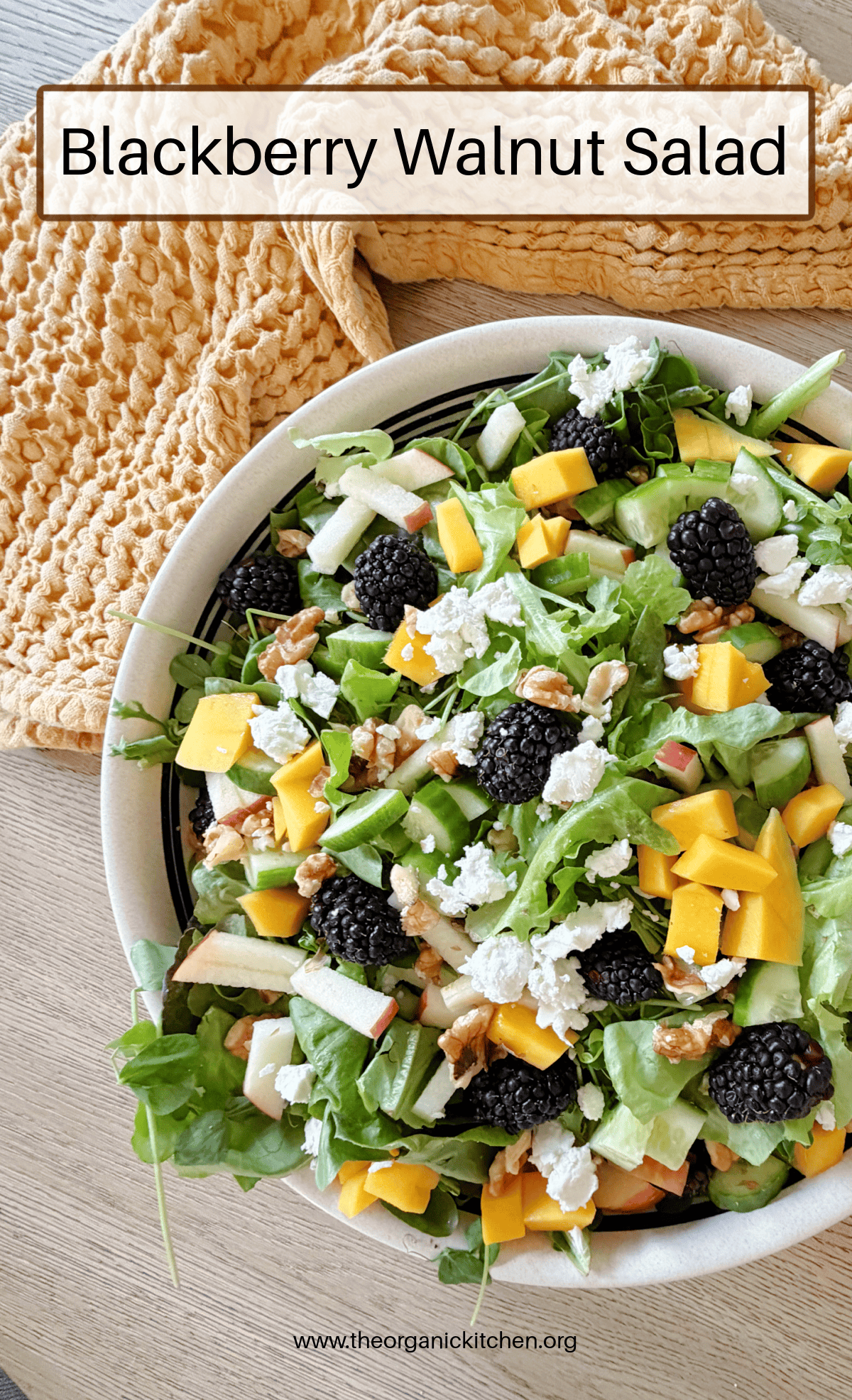 Blackberry Walnut Salad with Honey Vinaigrette in a white bowl on wood table with gold dish towel in background