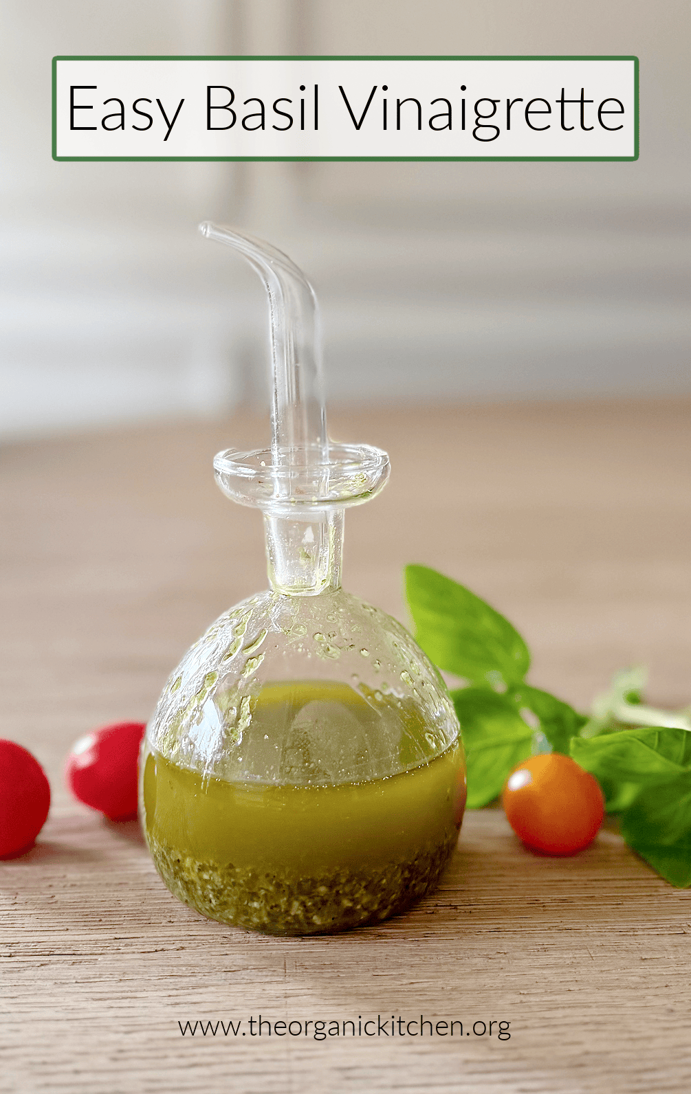 Fresh and Easy Basil Vinaigrette A small bottle of Fresh and Easy Basil Vinaigrette on a wooden table with cherry tomatoes and basil in the background
