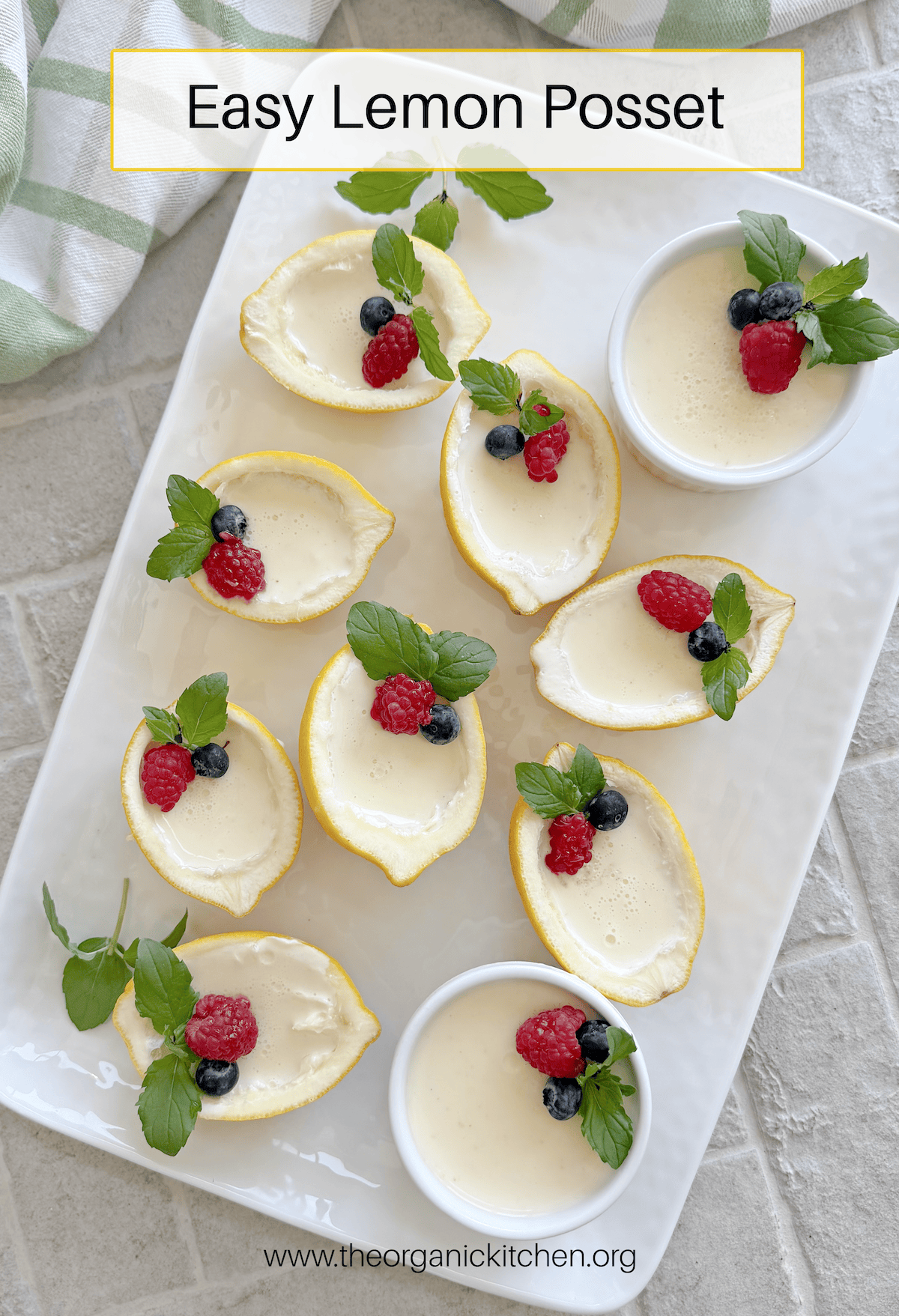Easy Lemon Posset Easy Lemon Posset- a white tray with lemon halves and ramekins filled with lemon custard garnished with mint and berries