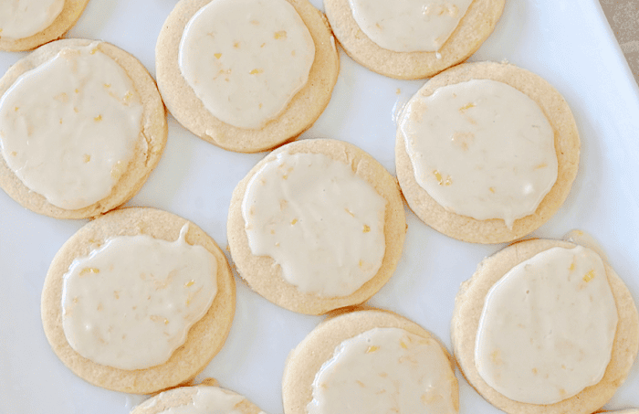 Simple Lemon Sugar Cookies Simple Lemon Sugar Cookies with lemon glaze on white platter