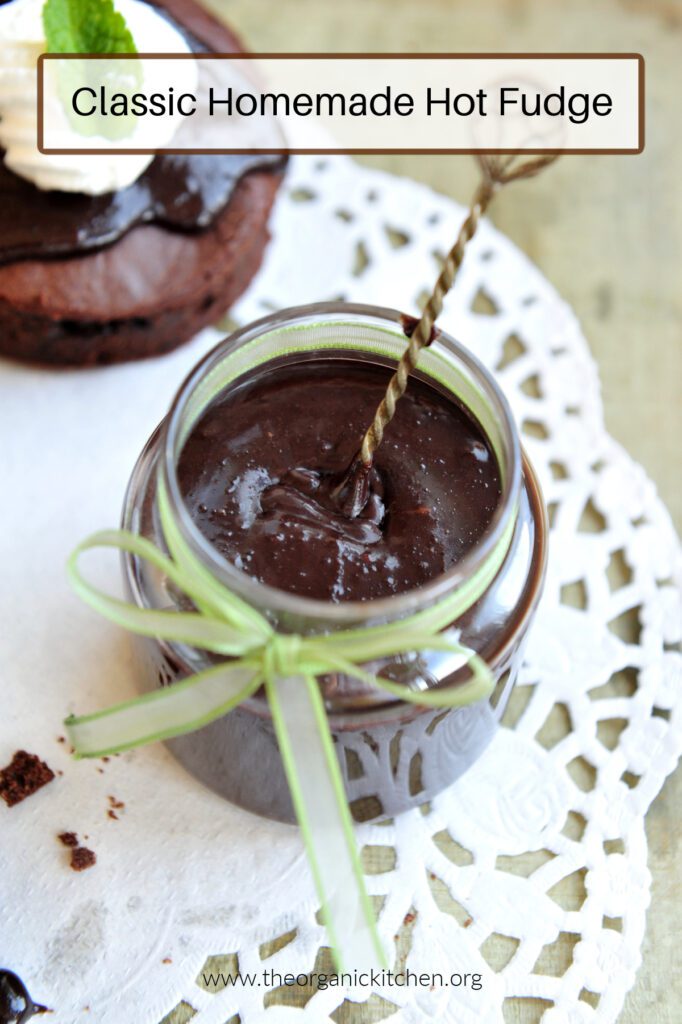 Twelve Delicious Chocolate Desserts! A mason jar filled with hot fudge sauce and tied with a green ribbon on white doily