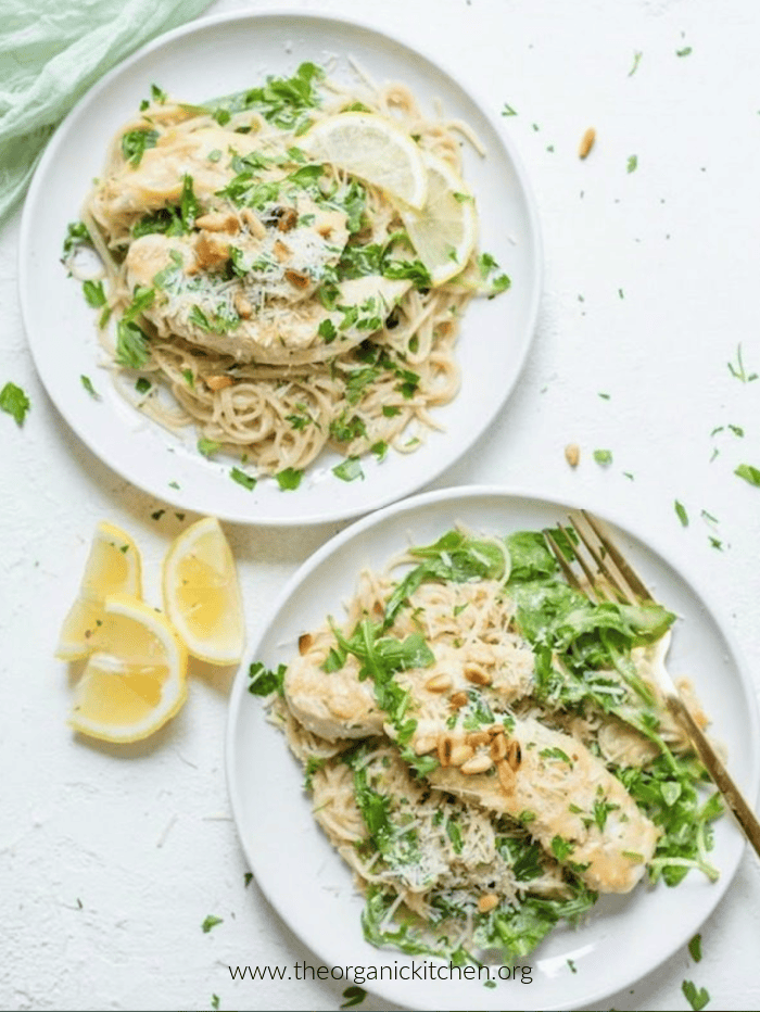 Chicken Piccata with Arugula on two white plates as a part of 12 Delicious Chicken Breast Recipes