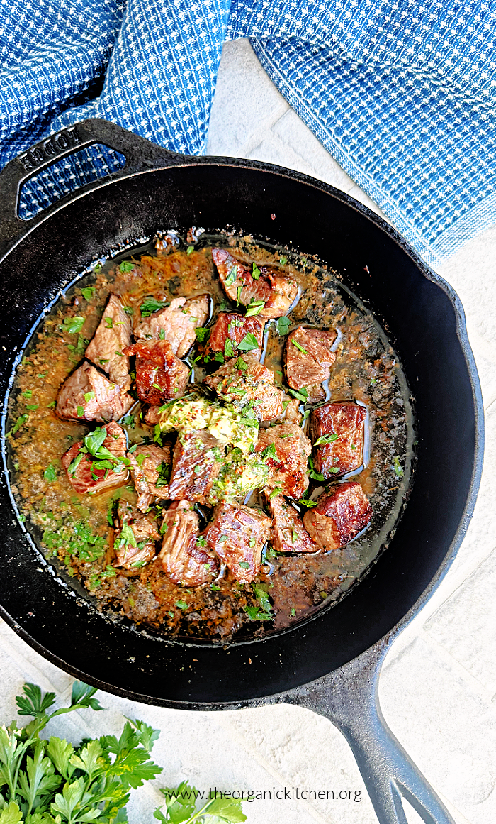 Cowboy Butter Steak Bites Cowboy Butter Steak Bites in a cast iron skillet with blue dish towel