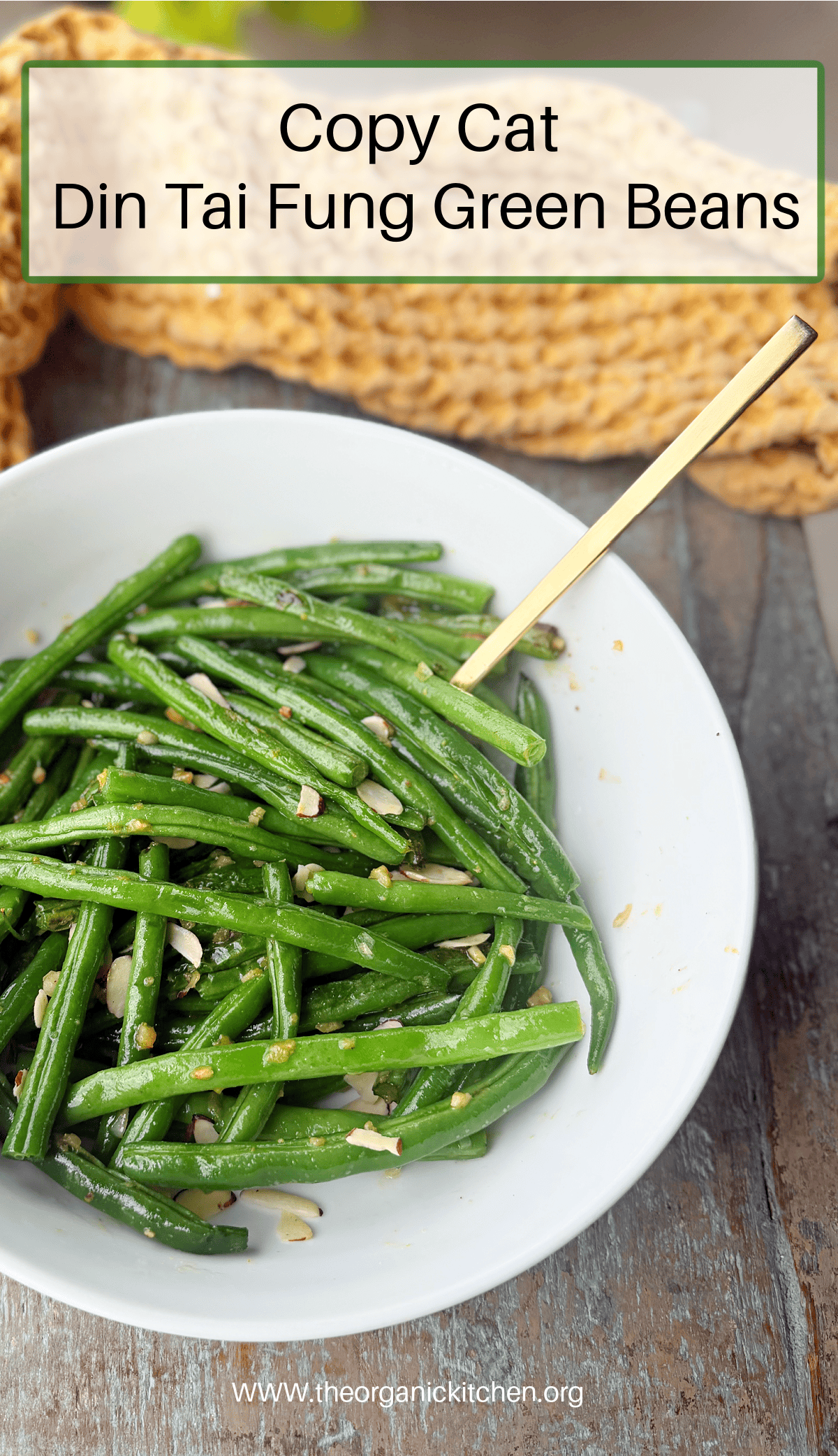 Copycat Din Tai Fung Green Beans in white bowl with a gold spoon 