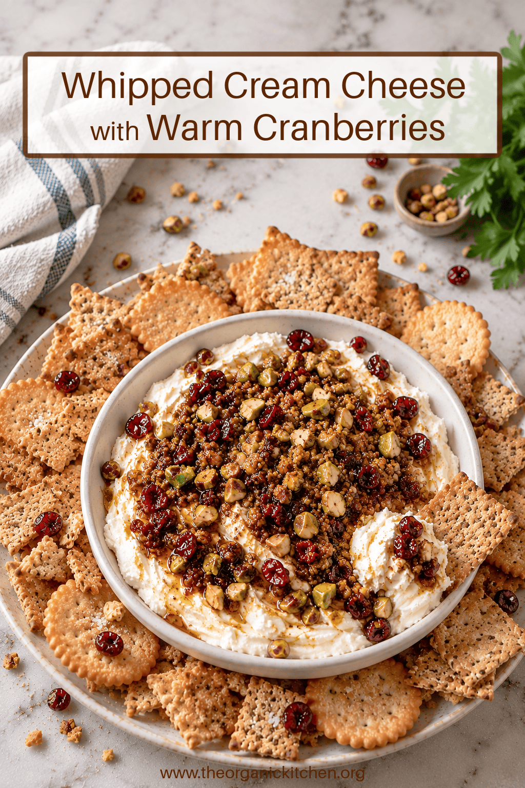 Whipped Cream Cheese with Warm Cranberries Whipped Cream Cheese with Warm Cranberries and pistachios in white bwol surrounded by crackers
